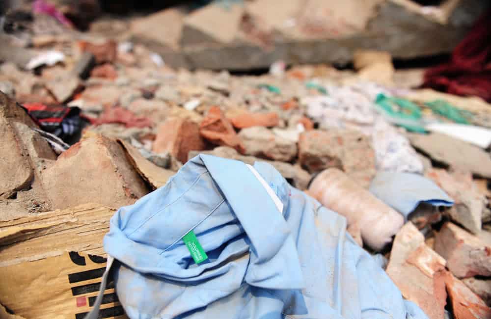 A shirt with a Benetton label lies in the detritus of Rana Plaza