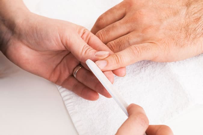 Man getting a professional hand manicure