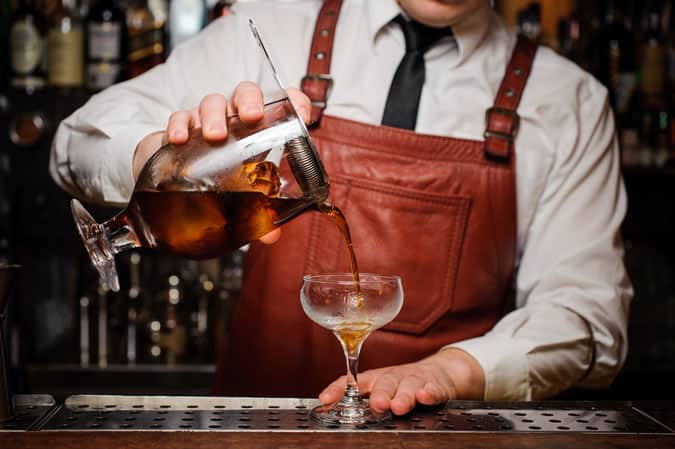 Straining a cocktail before serving