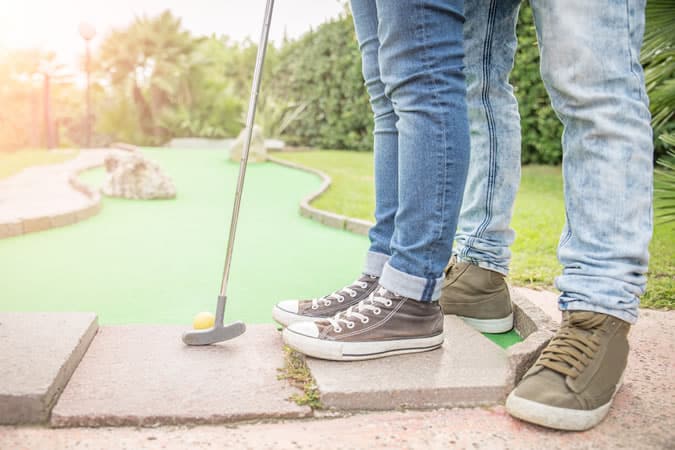 Couple playing crazy golf