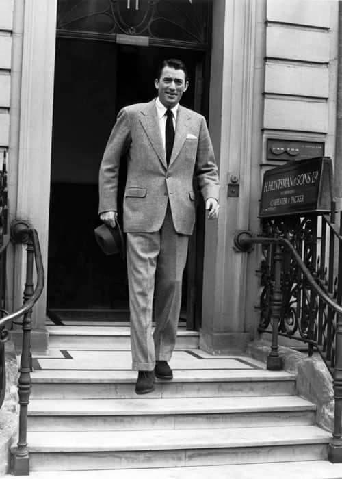 Gregory Peck wearing Huntsman outside their Savile Row store