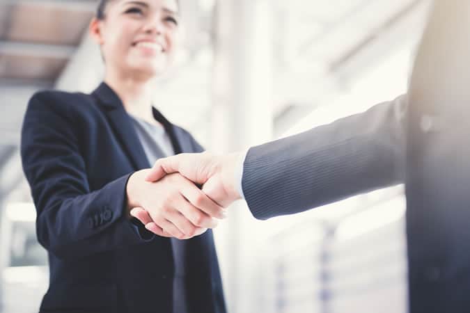Woman and man shaking hands