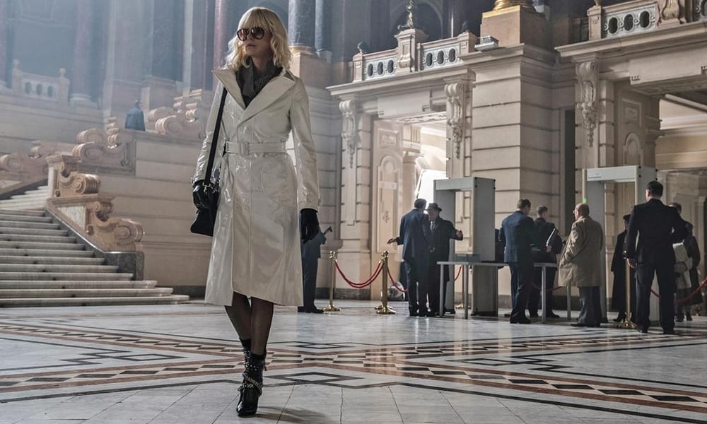 Charlize Theron Wearing A White Coat In Atomic Blonde