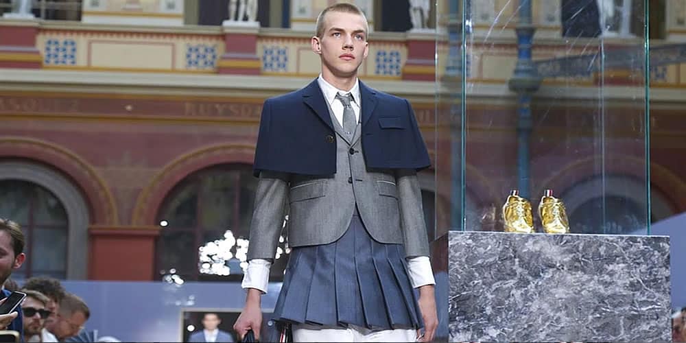 Model Wearing Shirts and Pleated Skirts At Thom Brown Fashion Show