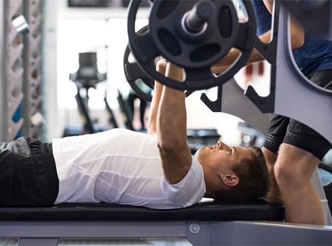 Man Bench Pressing At The Gym