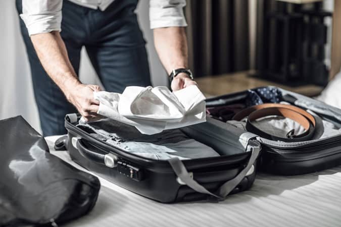 Man Packing A Suitcase