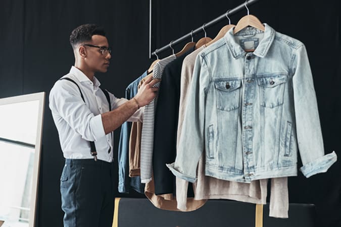 A Stylist With A Rack Of Clothes