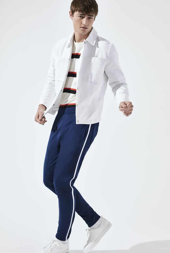 Man Wearing A Striped Top With Side-Stripe Trousers