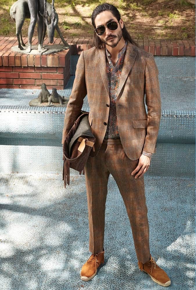 Man Wearing A Check Suit With A Paisley Shirt