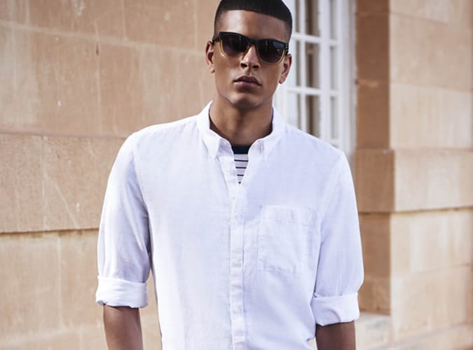 Man Wearing A White Shirt With Rolled Up Sleeves