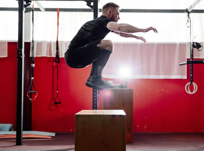 Man doing explosive box jumps