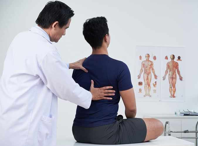 Doctor examining patient's posture
