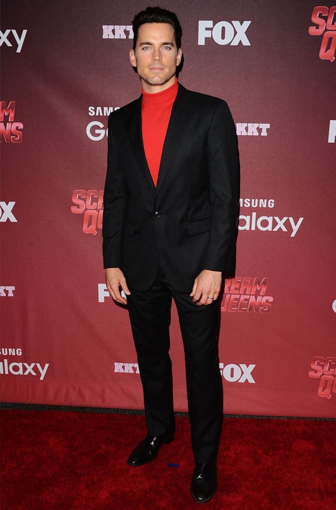 Matt Bomer Wearing A Suit And Red Roll Neck