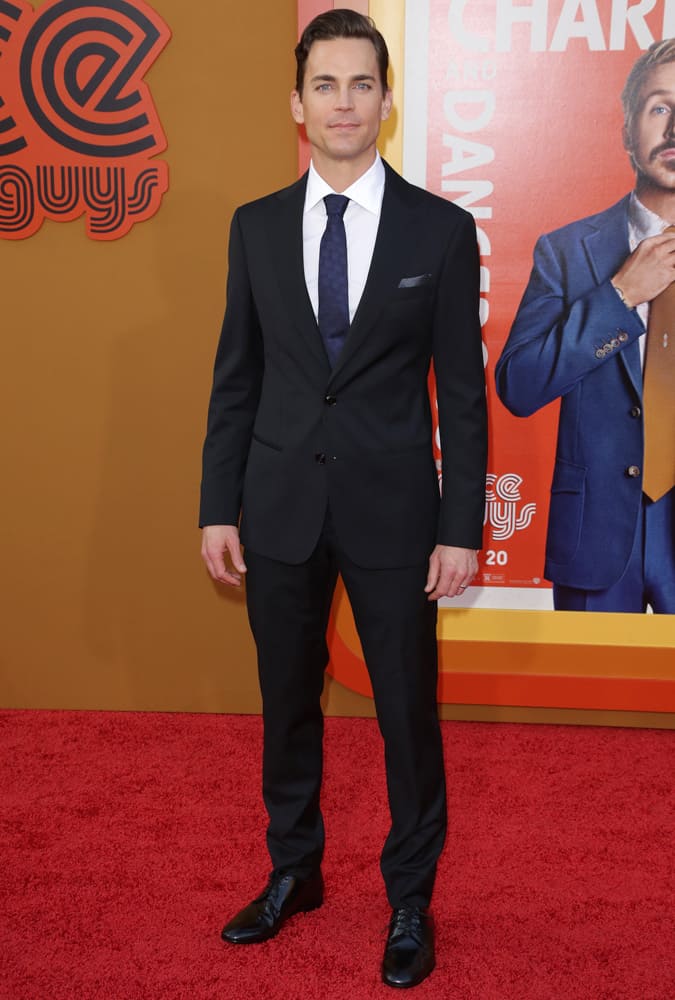 Matt Bomer Wearing A Navy Suit And Tie