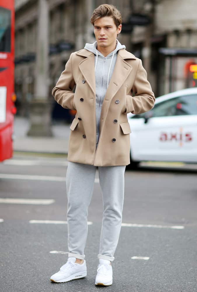 Oliver Cheshire Wearing A Tracksuit And Overcoat