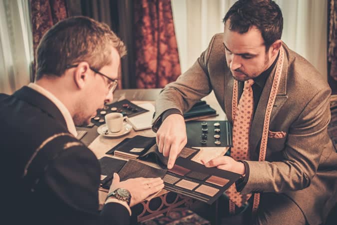 Man picking fabric for a suit