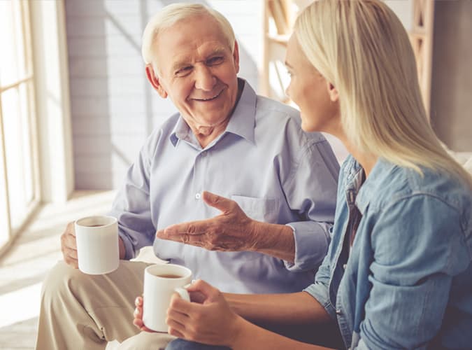 older man talking to young woman