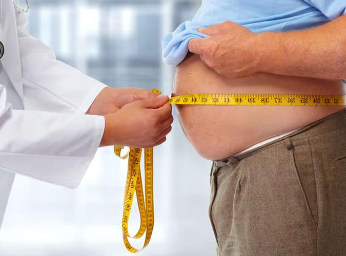 Overweight Man Being Measured