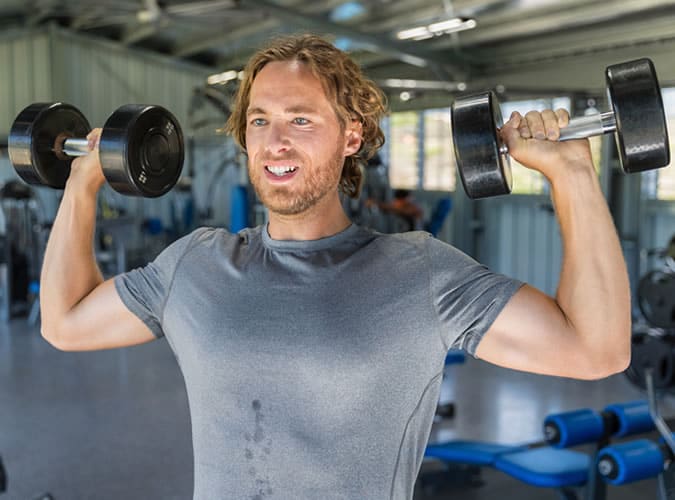 Man doing dumbbell burpees