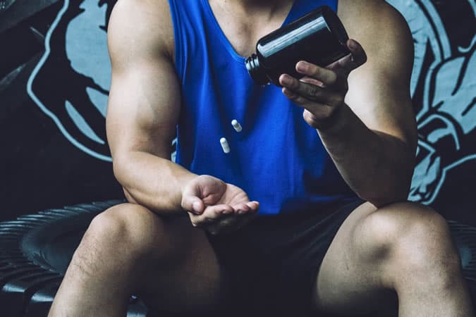 Man taking testosterone booster pills