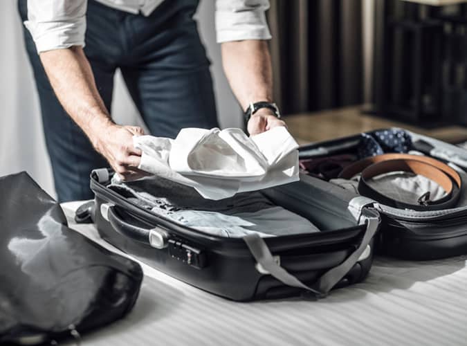 Man packing suitcase