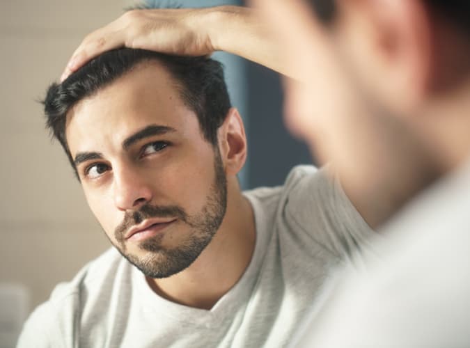 man checking hair line