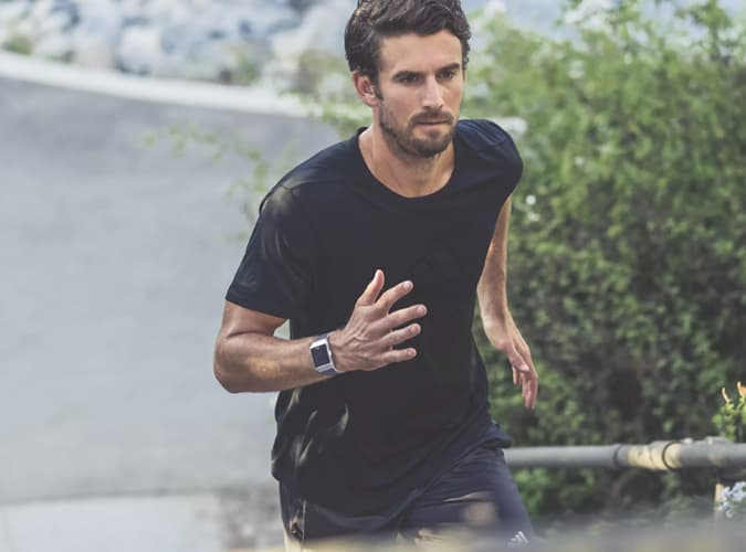 Man Running Wearing A Fitness Watch