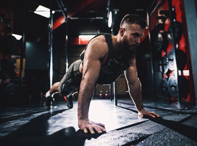 man working out with a weighted vest on