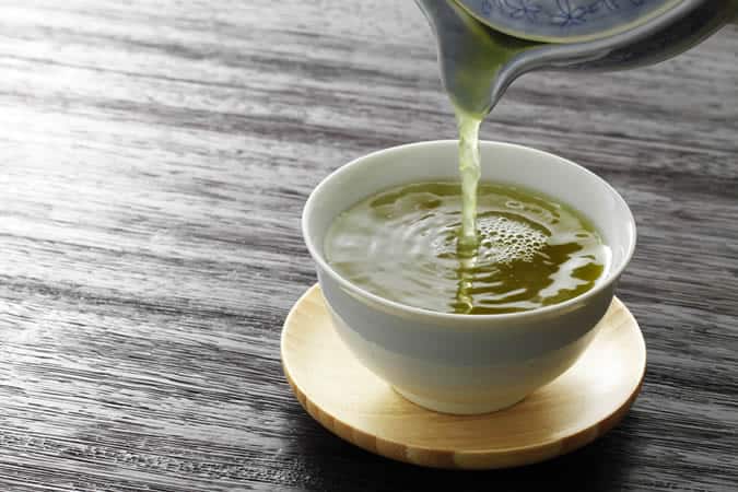 Pouring a cup of green tea