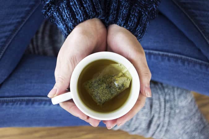 Holding a cup of green tea