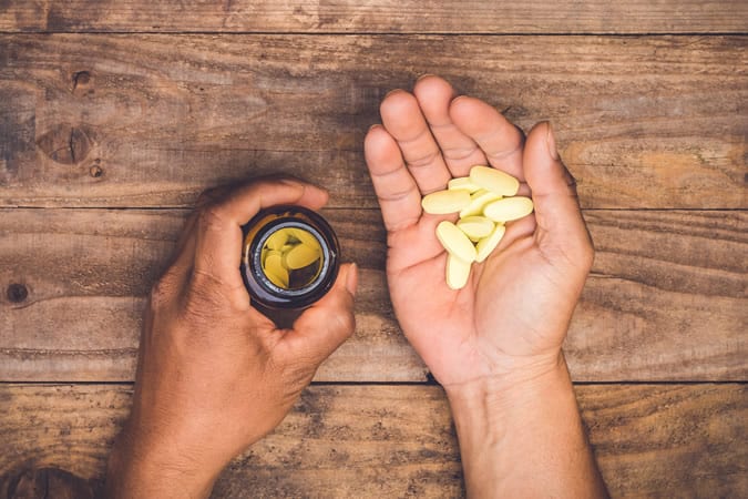 Man Holding Vitamins
