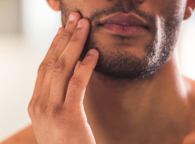 Man touching facial hair