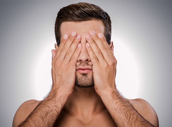 Man hiding his face