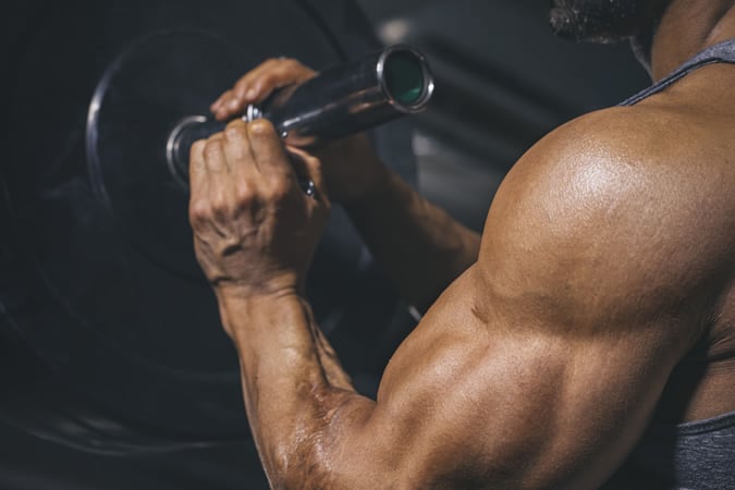 Bodybuilder preparing a barbell