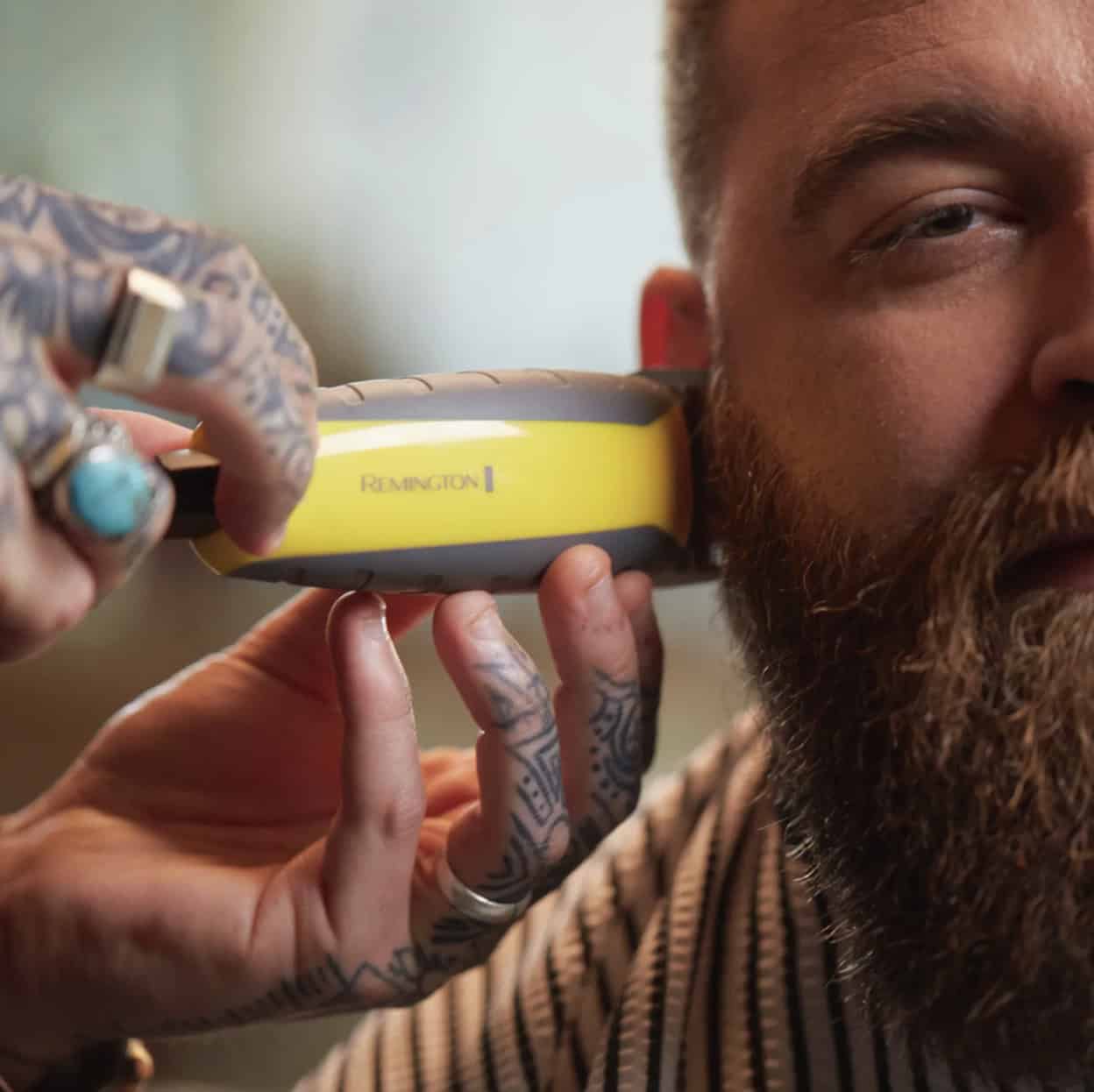 Man with beard trimmer