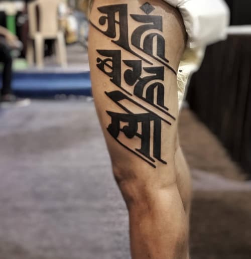Calligraphic blackwork tattoo