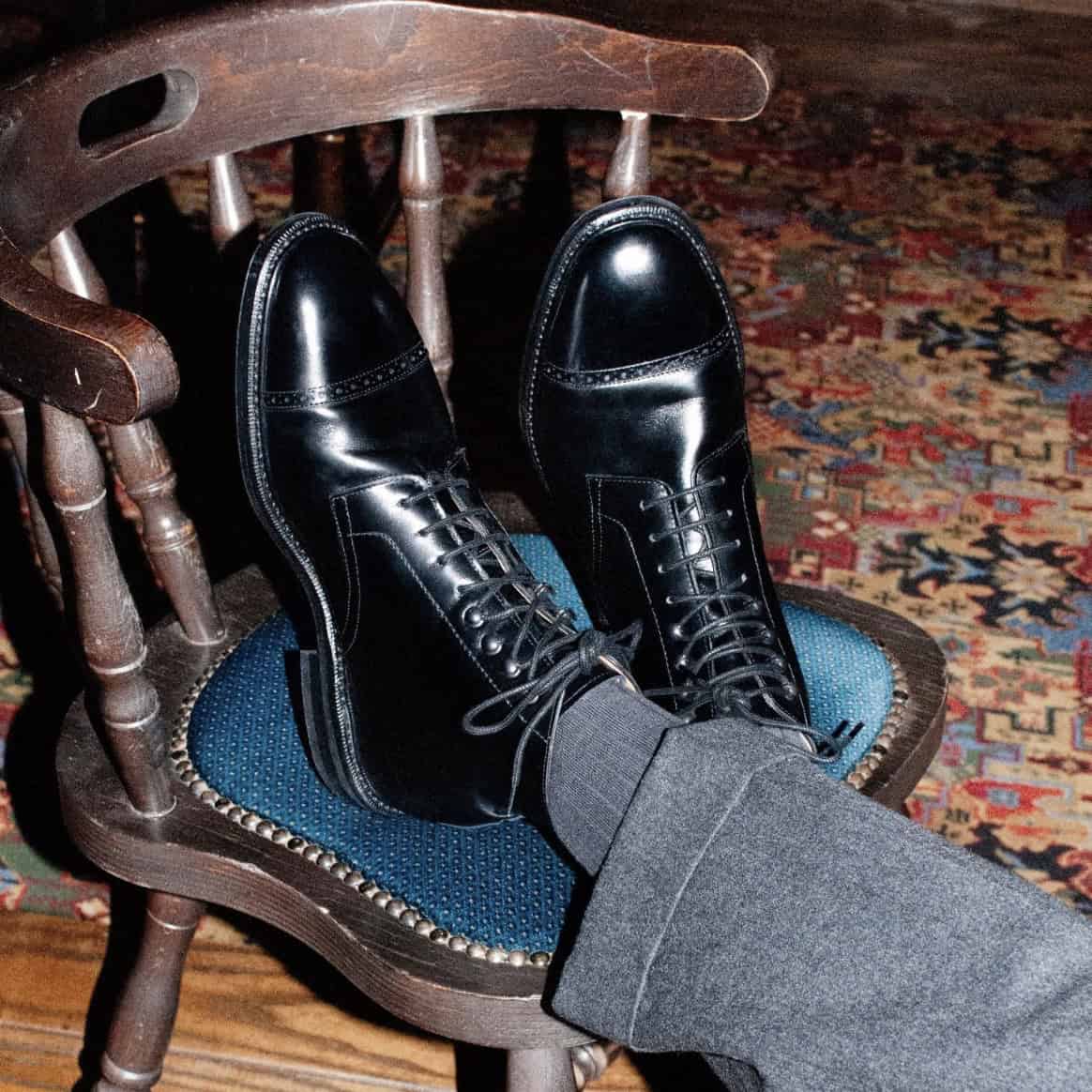 mens shoes on a blue velvet chair