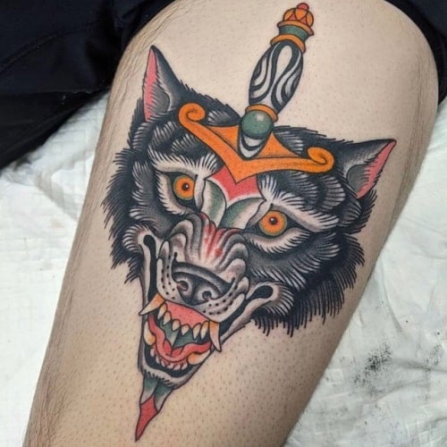 Wolf and dagger tattoo
