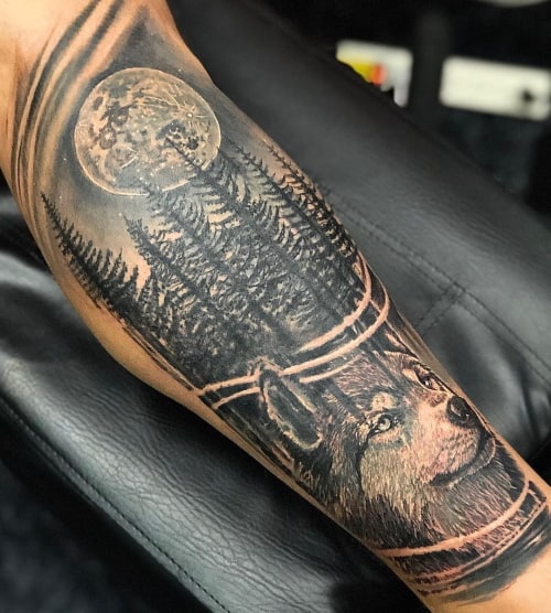 Wolf in woods tattoo 
