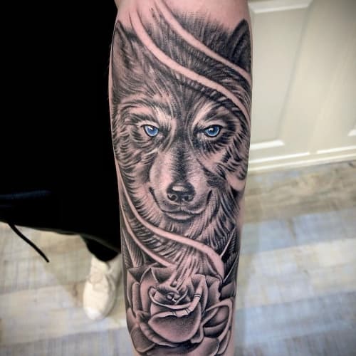 Wolf with rose tattoo