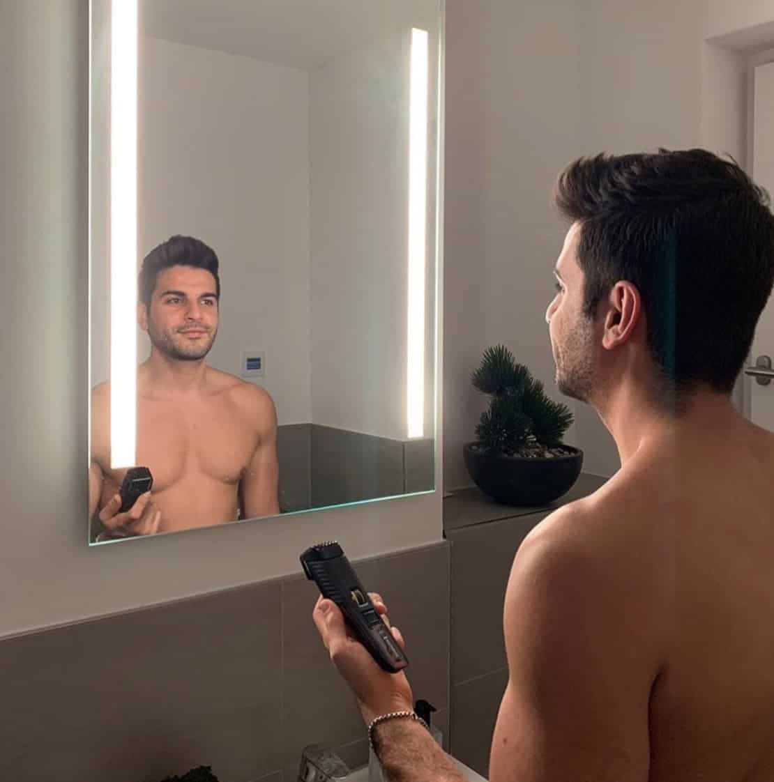 Man with beard trimmer
