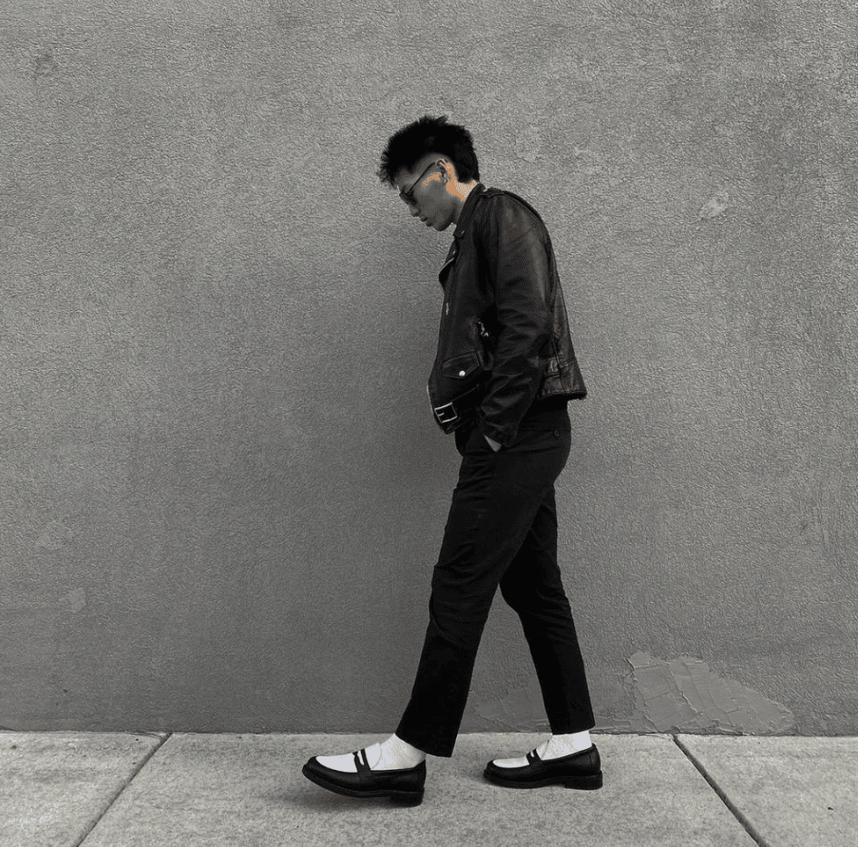 Person wearing black and white shoes 