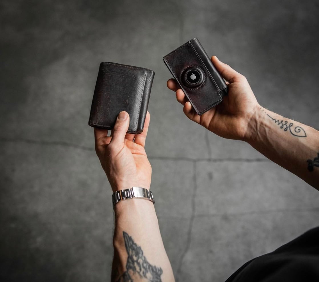 man holding a leather wallet 