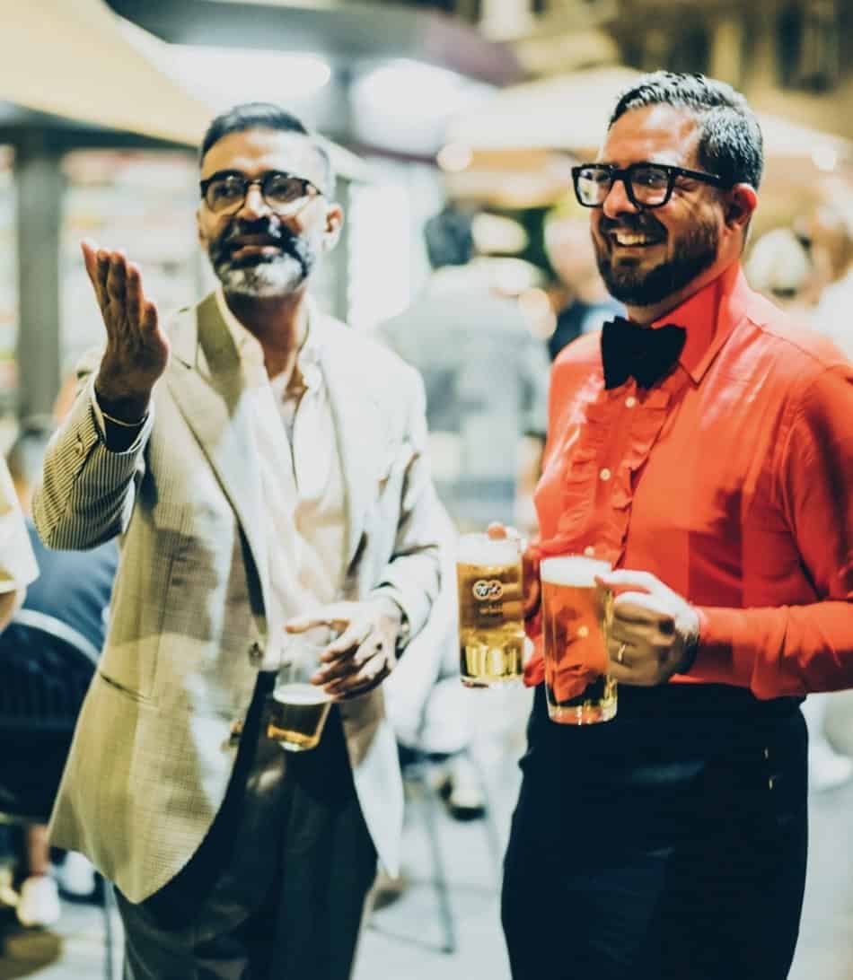 Two men in formal wear smiling