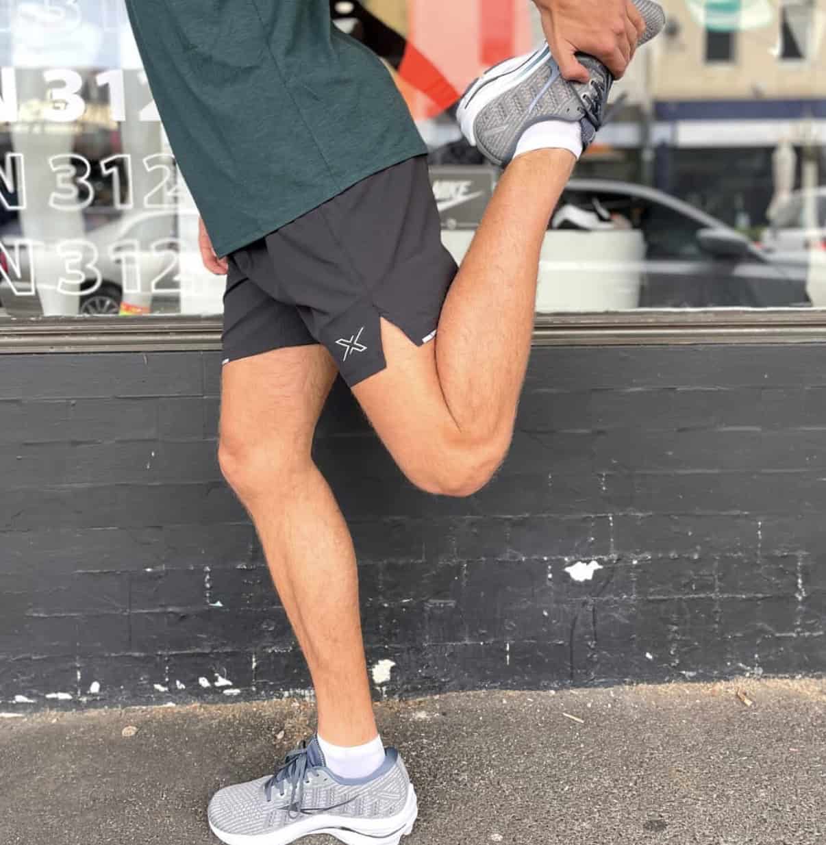 Man wearing the best running shorts while stretching