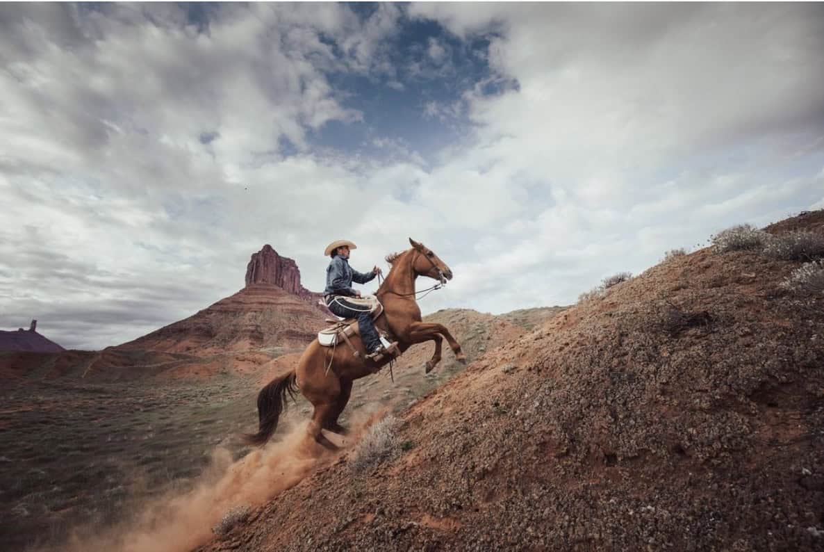 Cowboy riding a horse in the desert
