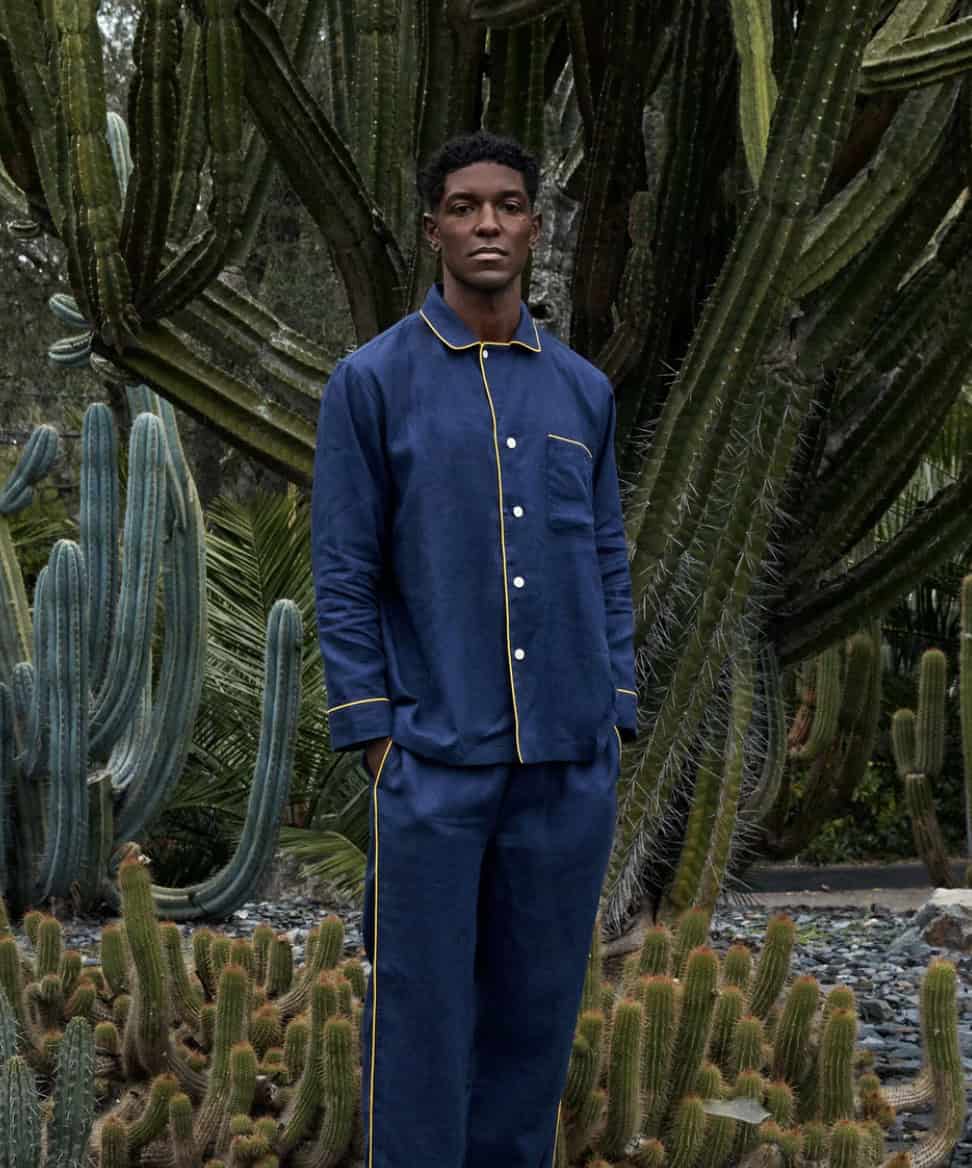 man standing in front of cactus in pajama set