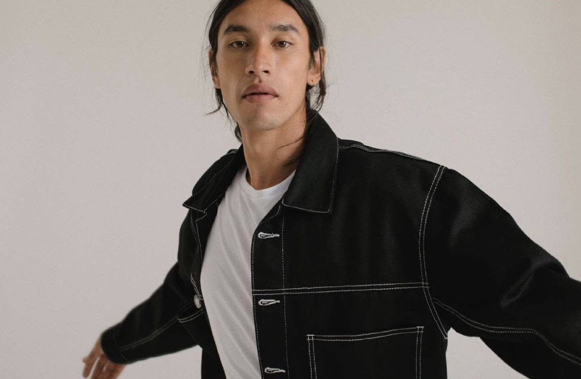 man wearing the best black denim jacket and white shirt, with arms out