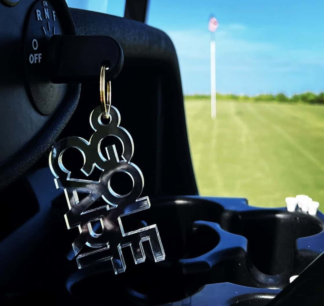 Close up of a golf cart key chain that says 'Golf Cart'