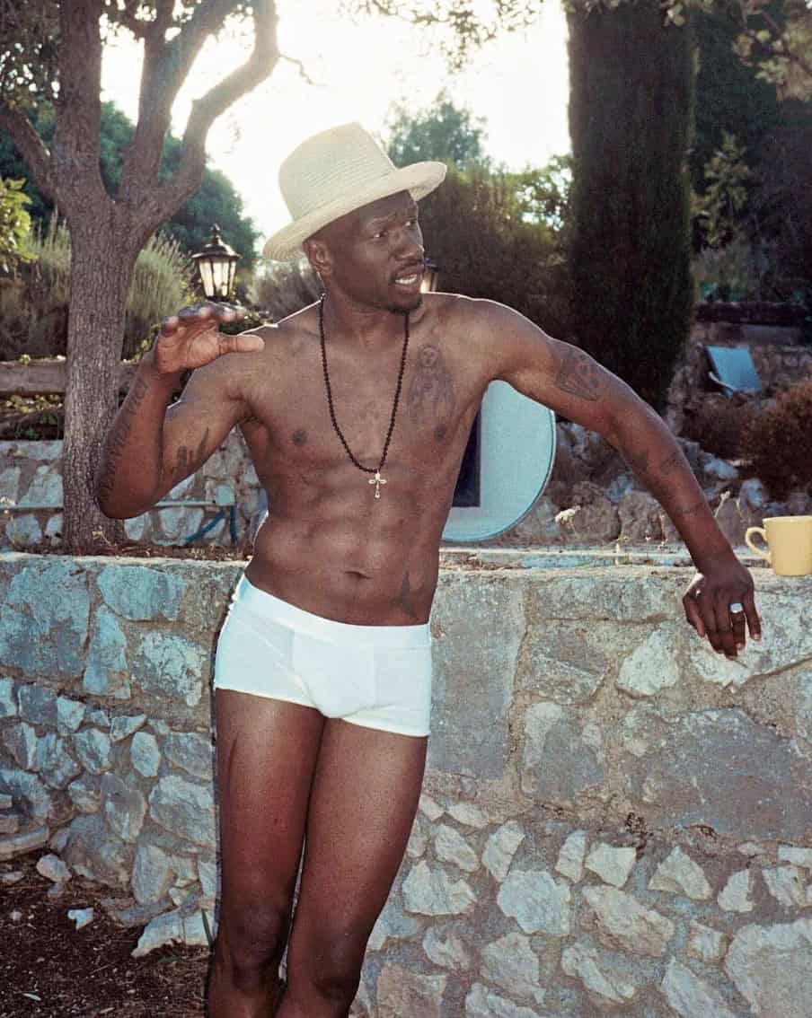 Man Standing against a stone half wall in the best boxer briefs